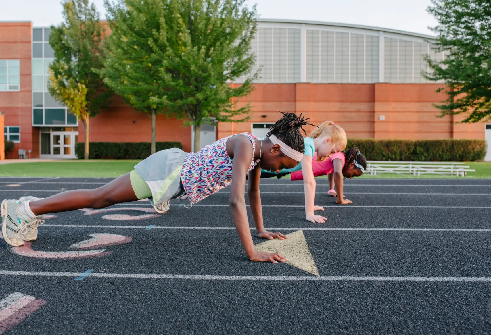 Elementary school kids doing pushups on running track | Rockwall Homes for Sale