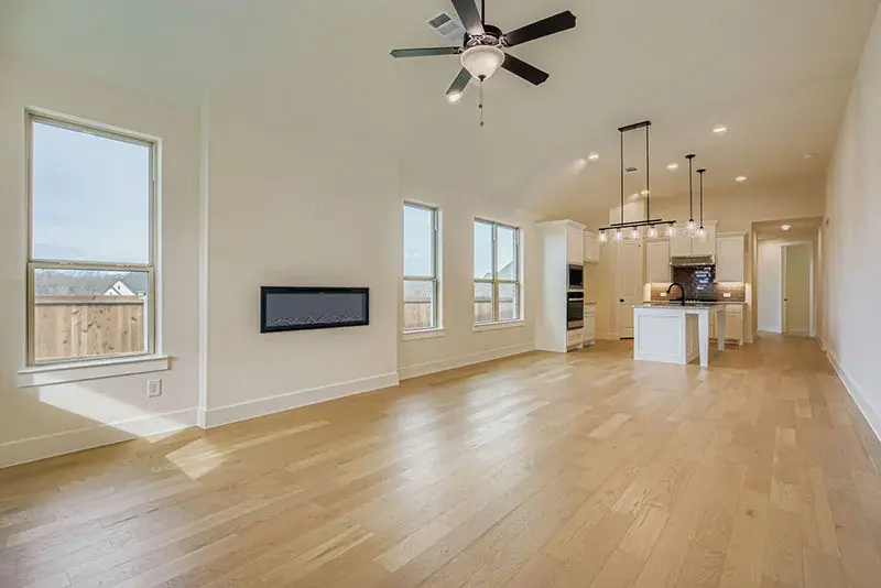 Open-concept kitchen with a large island and connected family room in an American Legend floor plan at Hillstead
